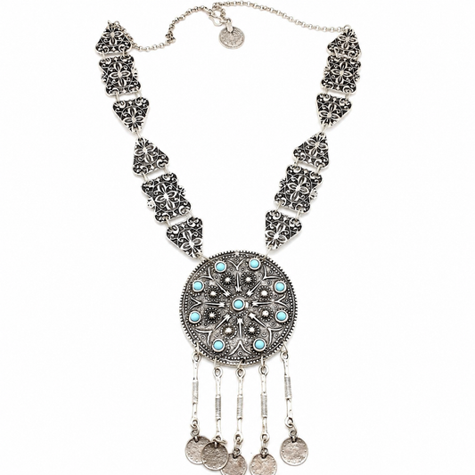 Silver-tone necklace with turquoise accents and a coin-inspired pendant.