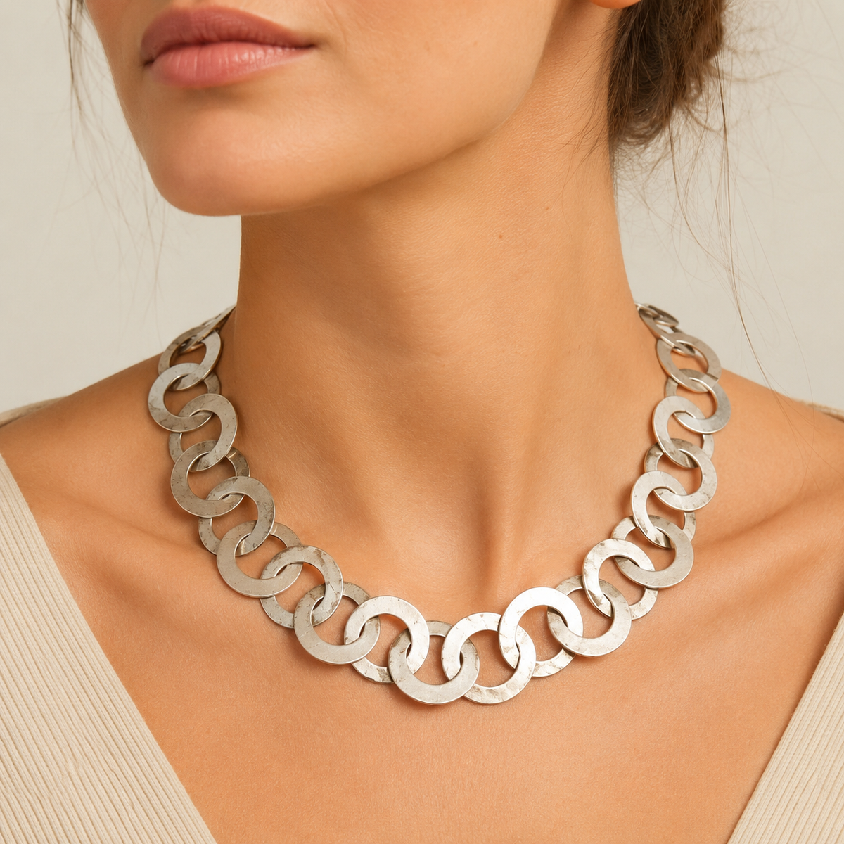Silver-tone circle link necklace shown from above on a white background.