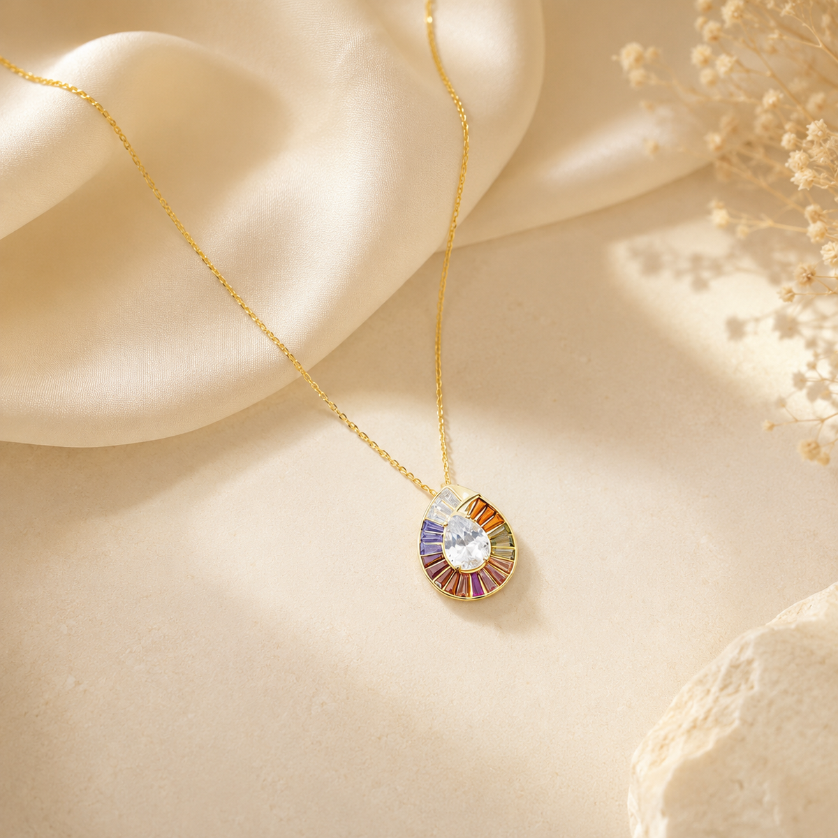 Gold-tone pendant necklace with colorful CZ details and a delicate chain.