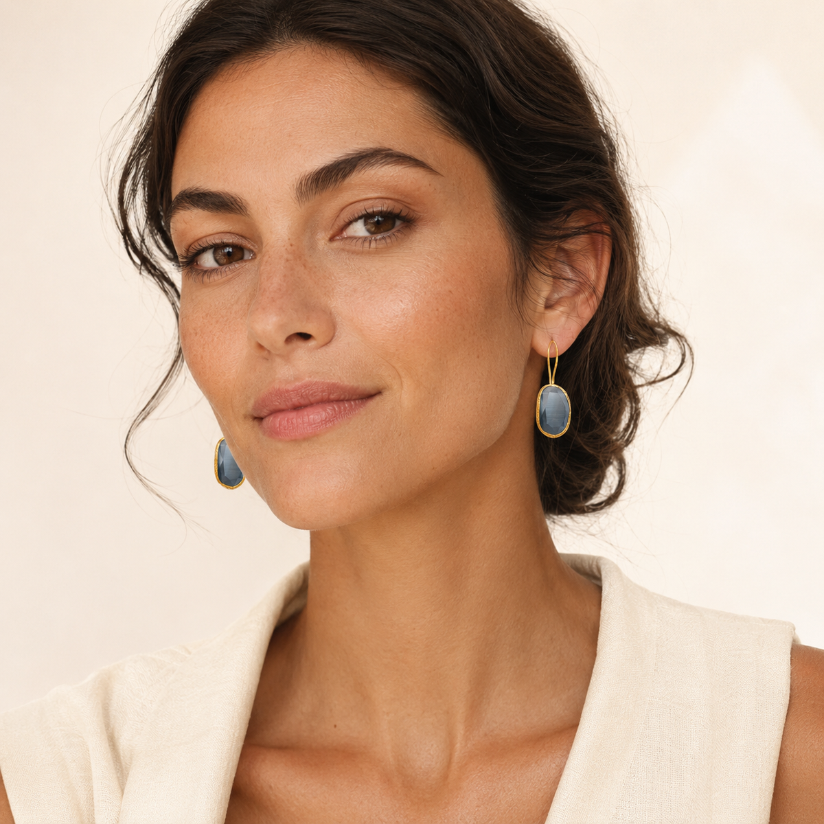 Smoky gray cat eye drop earrings with a polished gold-tone look.