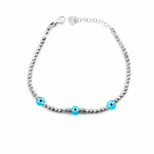 Silver-tone beaded bracelet with bright blue eye accents on a white background.