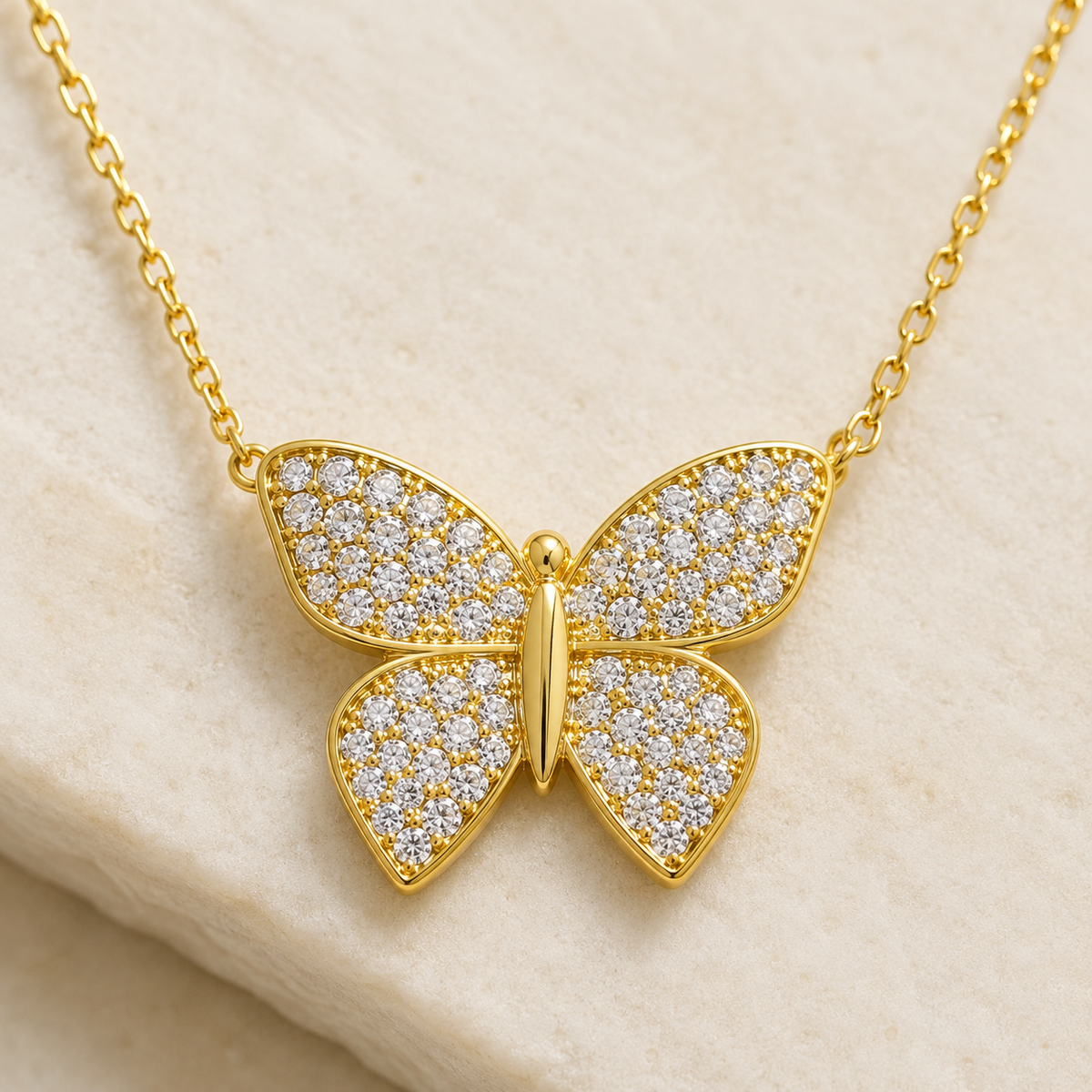 Close view of a butterfly pendant necklace with pavé-inspired sparkle.