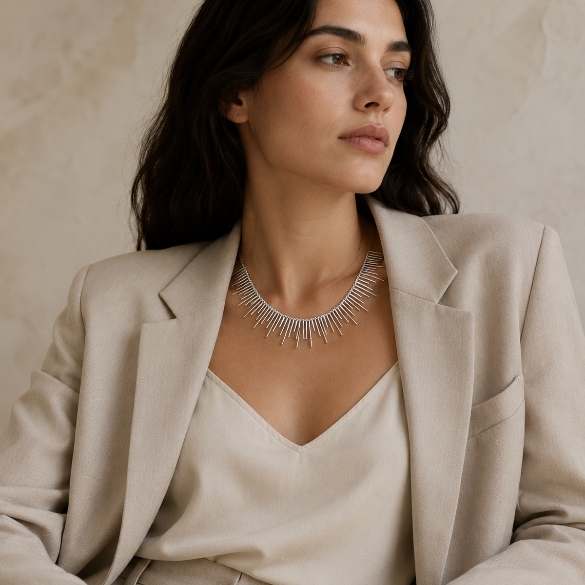 Silver-tone spike collar necklace styled as a bold statement piece.