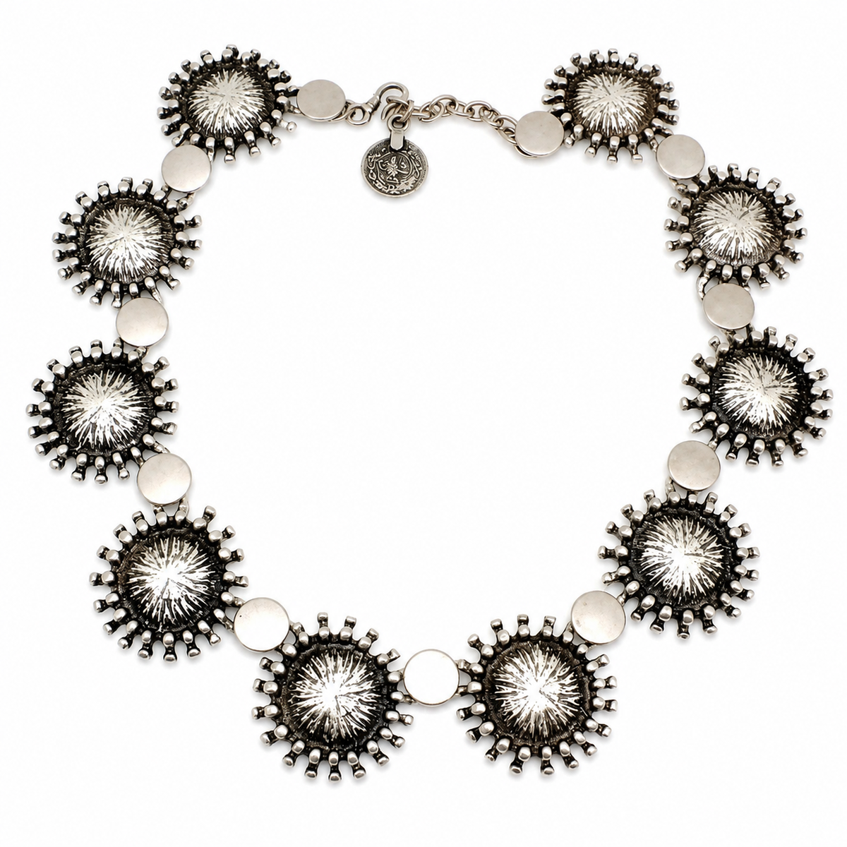 Silver-tone collar necklace with sunburst disc details arranged in a bold circular shape.