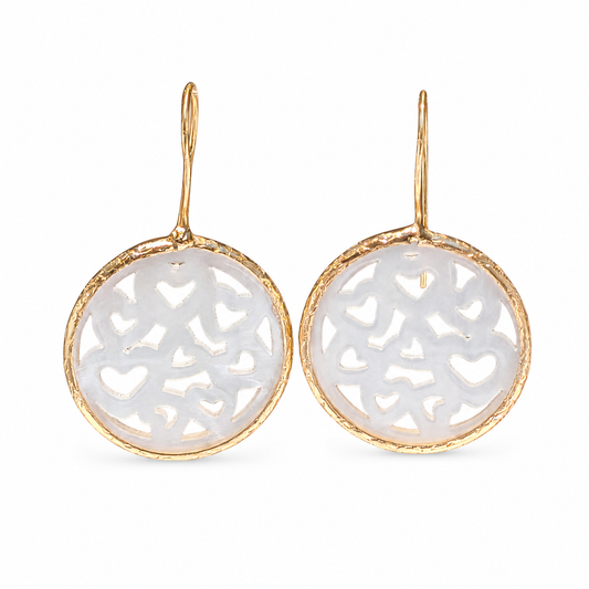 Gold-plated drop earrings with mother of pearl heart cutouts.