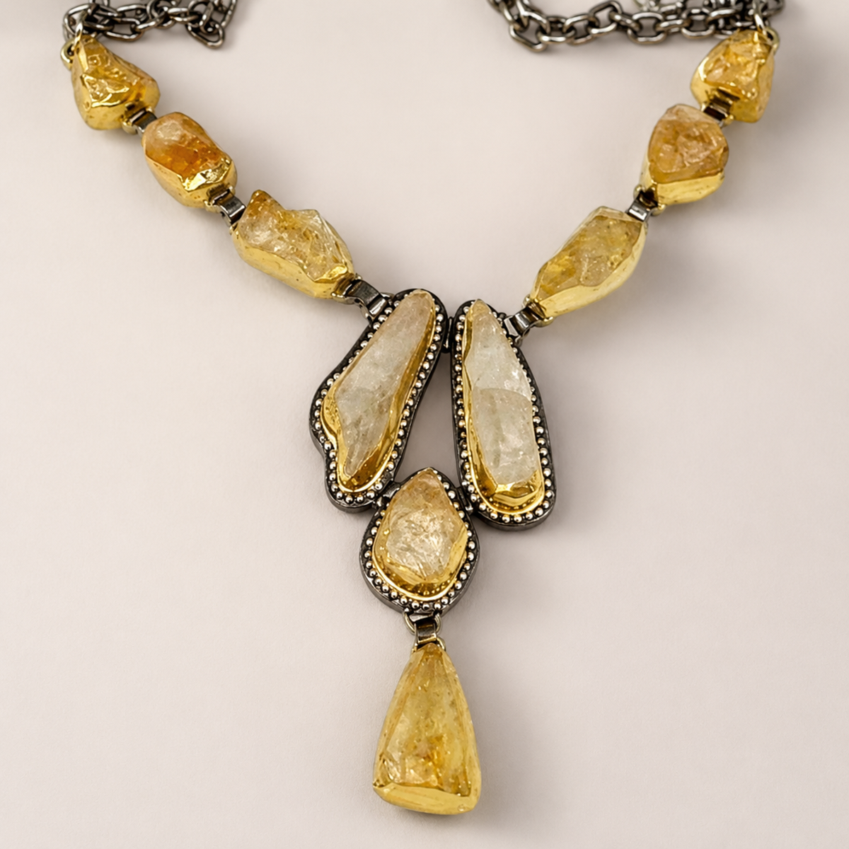 Close view of the raw citrine stones and gold-tone settings.
