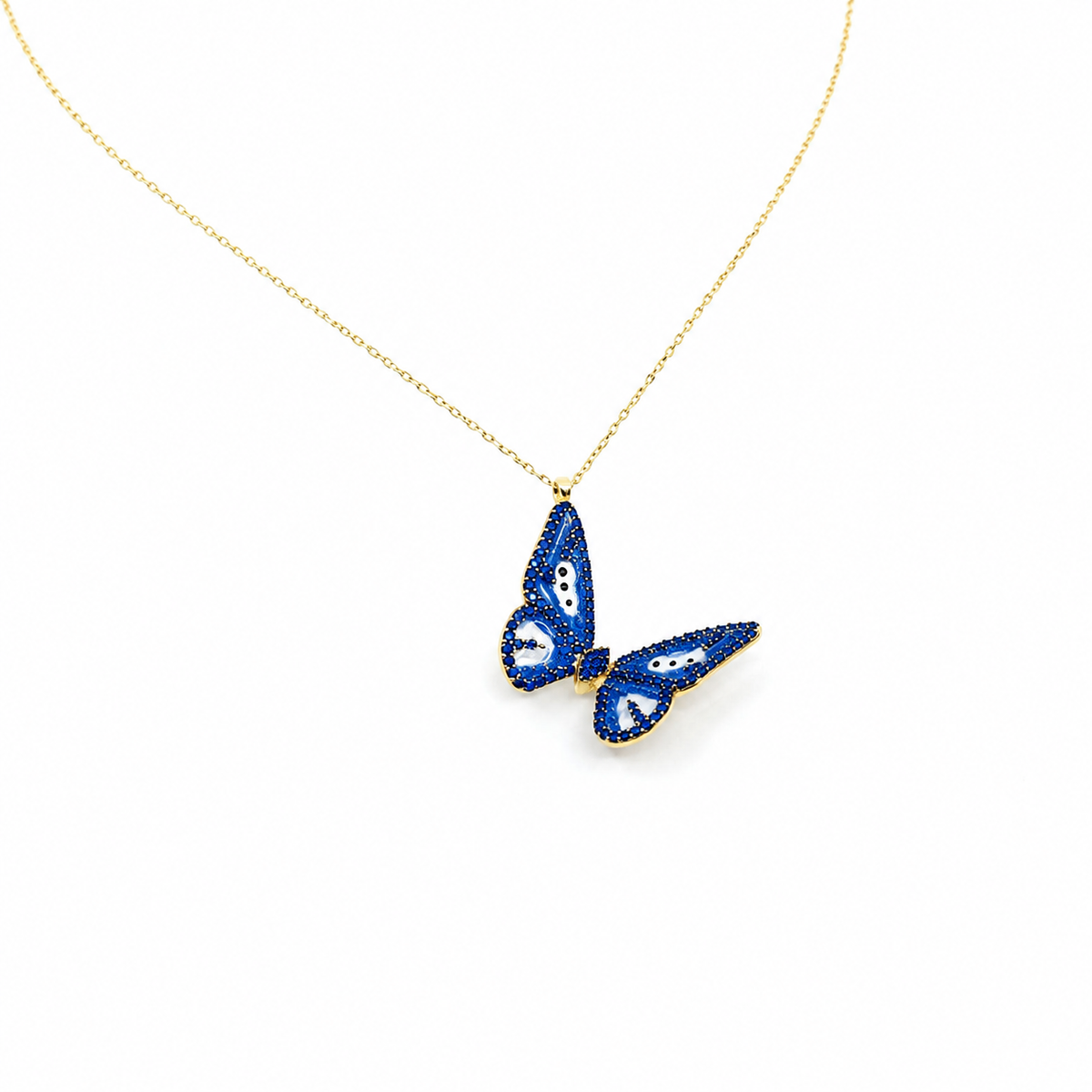 Angled view of a gold-tone butterfly pendant necklace with navy enamel.