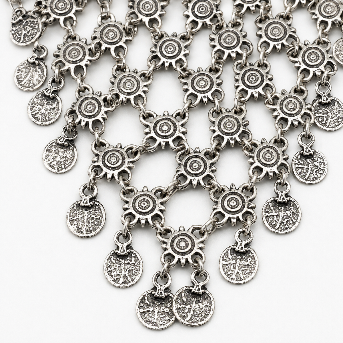 Close view of the necklace’s detailed coin charms and textured silver-tone finish.