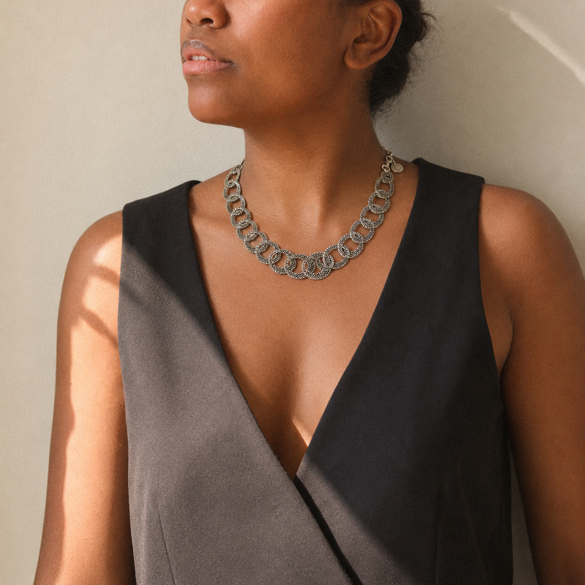 Textured silver oval link necklace with a sculptural chain design.