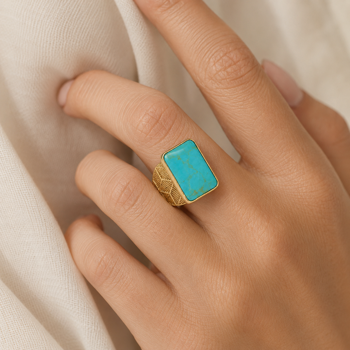 Square turquoise ring shown in a gold-plated finish with a bold, sculpted silhouette.