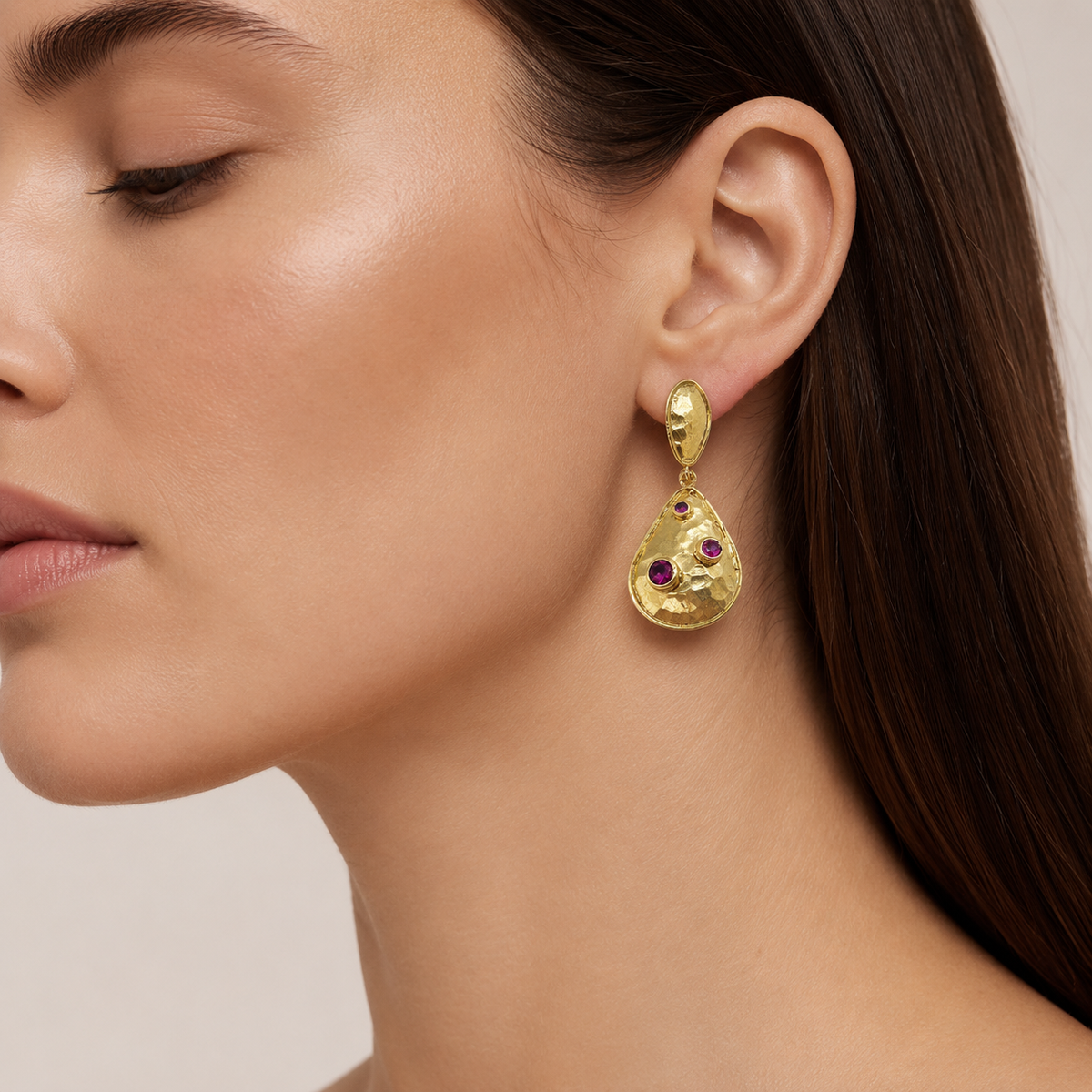 Gold-plated teardrop earrings with clear crystal accents shown front view.