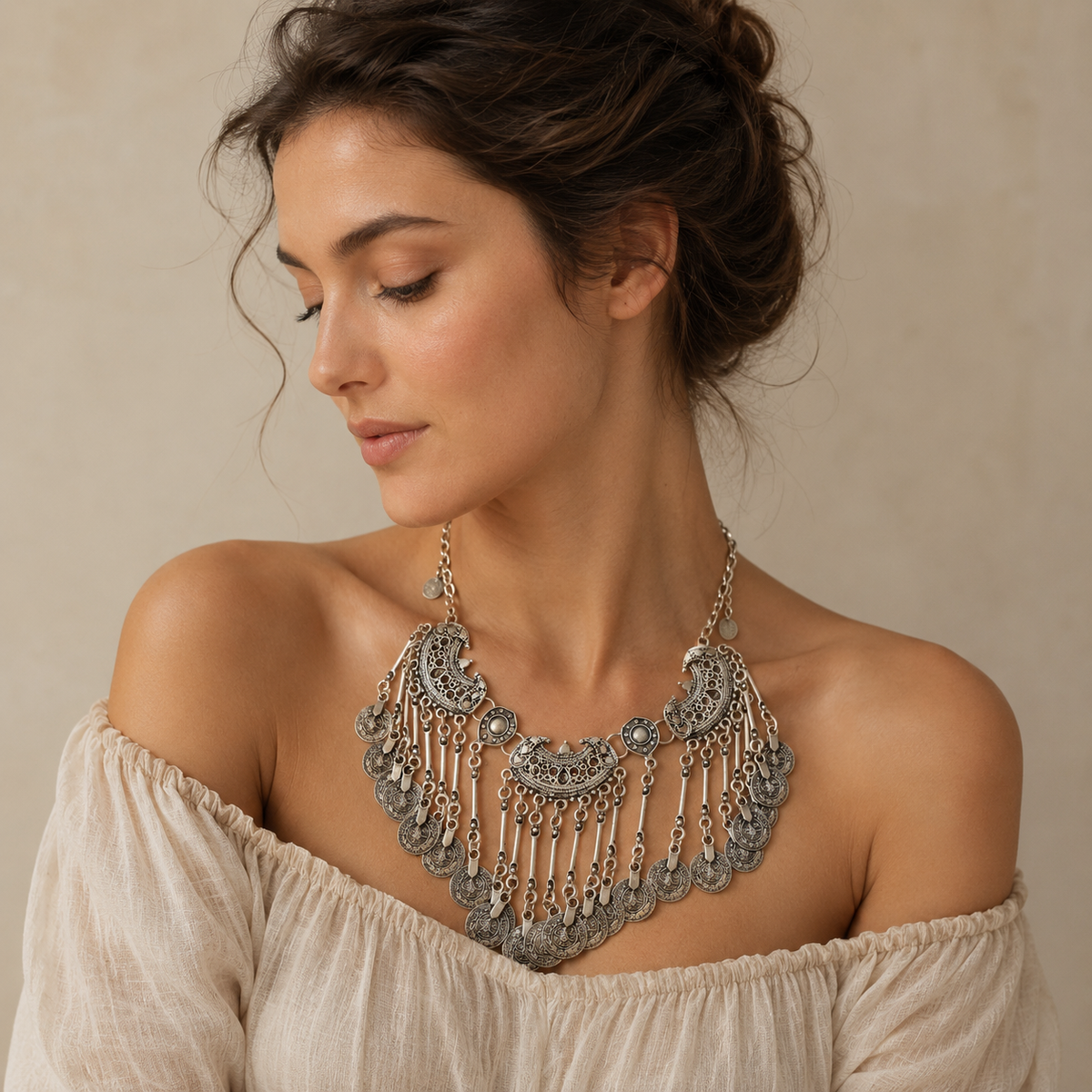 Ornate silver-tone necklace with textured coin fringe.