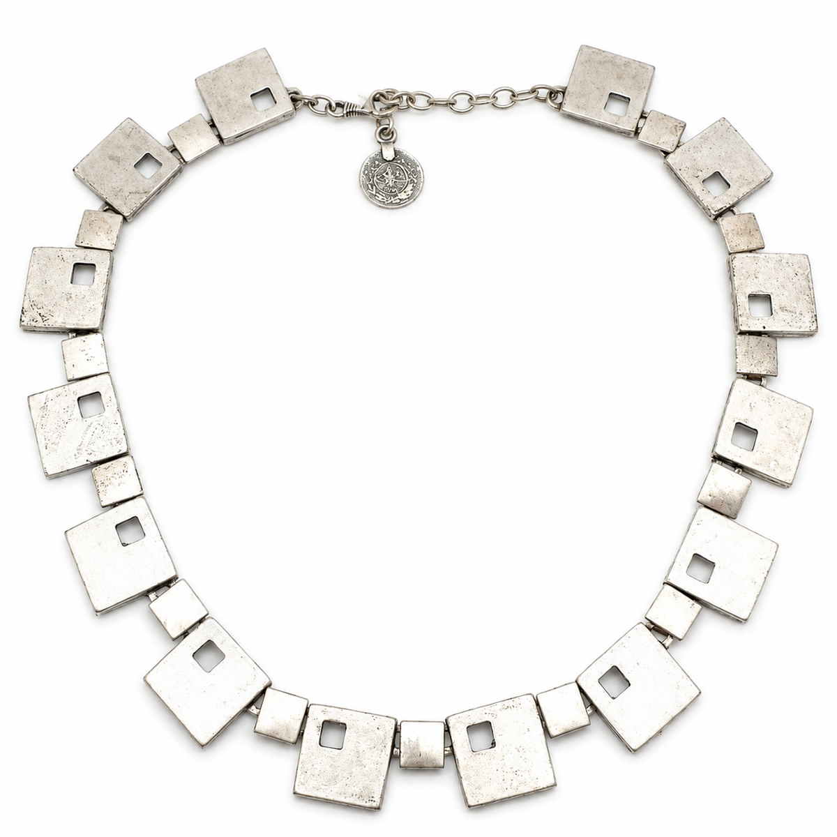 Silver-tone necklace with geometric square links arranged in a statement silhouette.