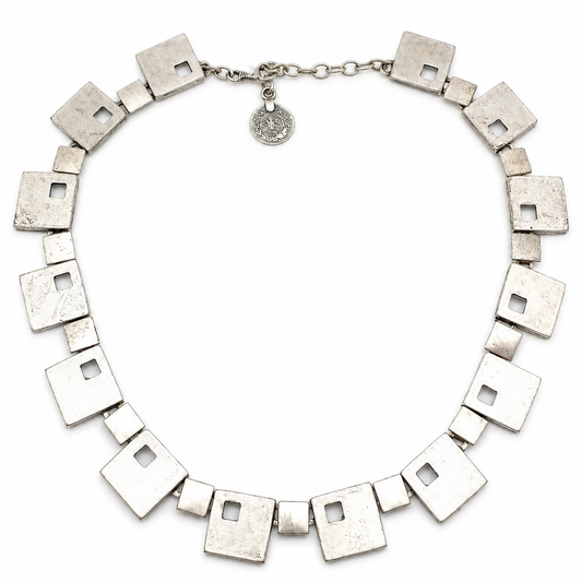 Silver-tone necklace with geometric square links arranged in a statement silhouette.