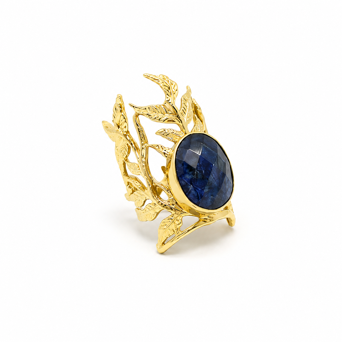 Gold statement ring with a navy blue oval center stone and leaf filigree detail.
