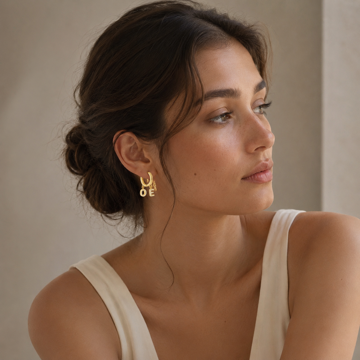 Gold-tone initial earrings with sparkling CZ details.