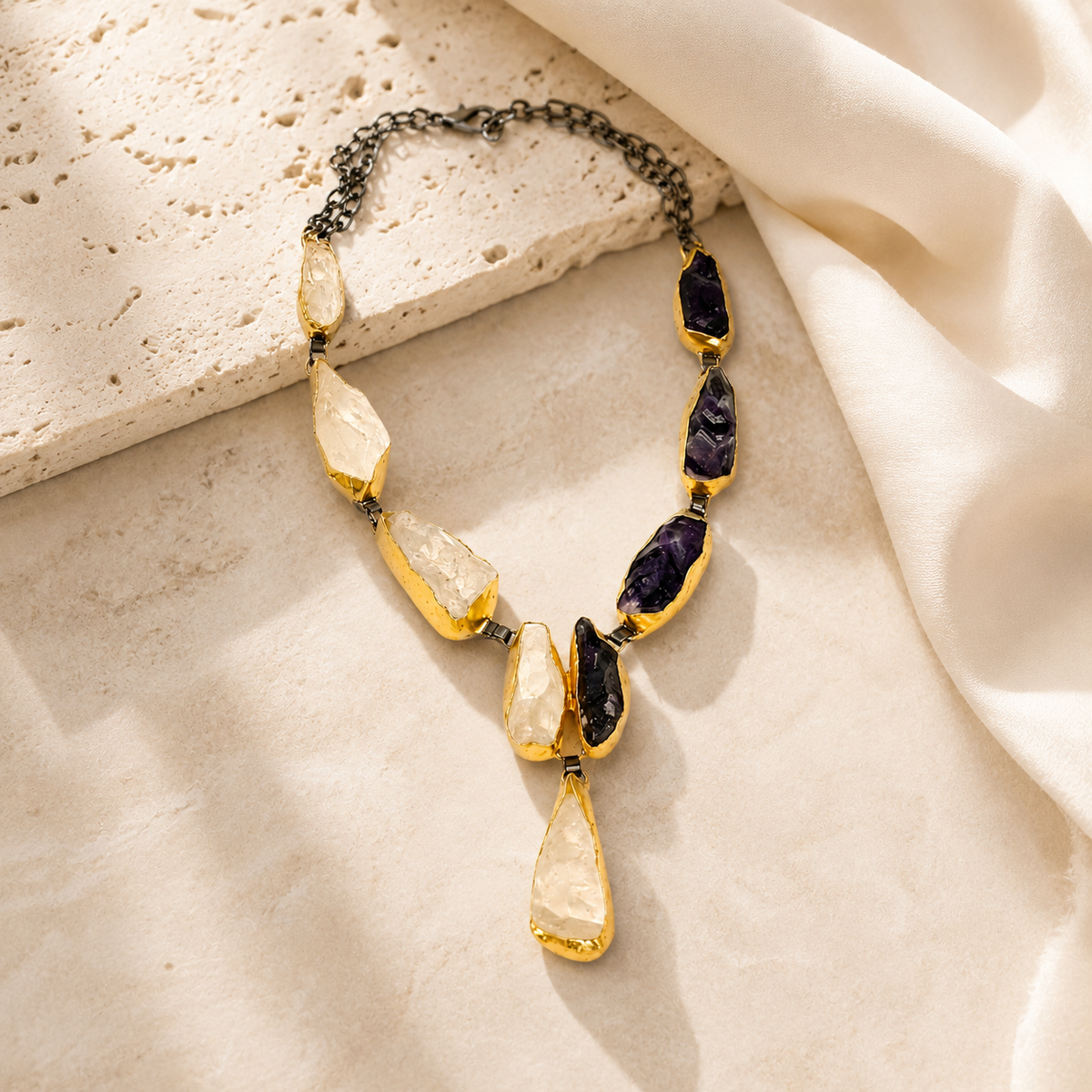 Statement necklace with alternating purple and crystal-like stones in a Y silhouette.