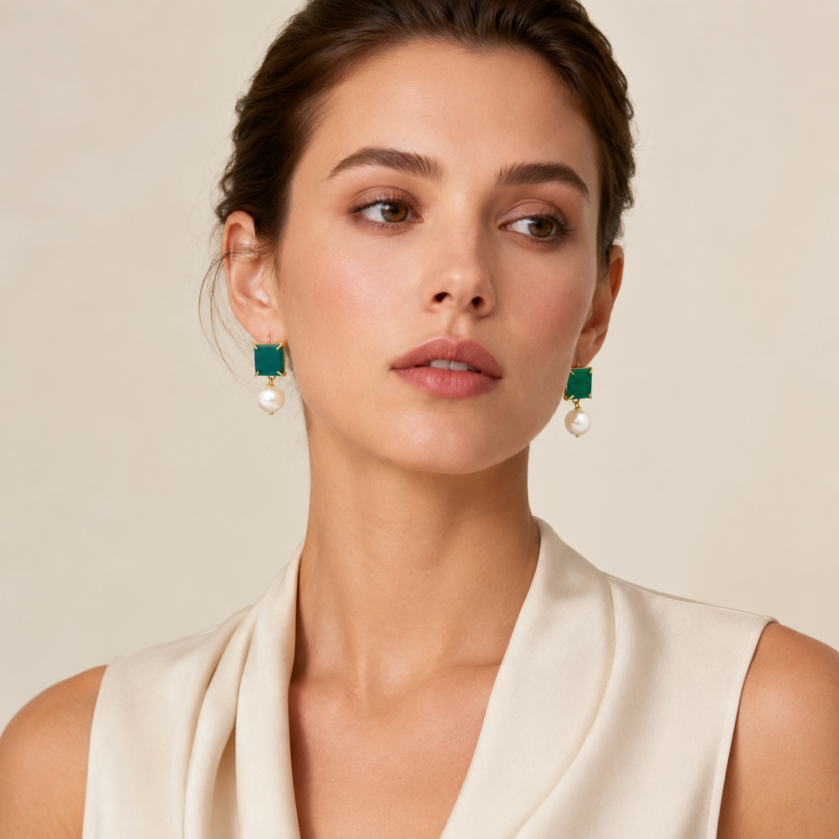 Pair of green chalcedony and pearl drop earrings in a clean studio image.