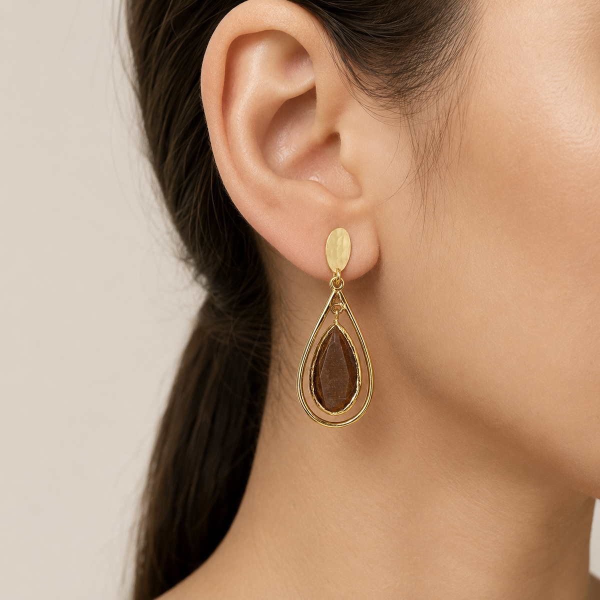 Brown teardrop drop earrings with a gold-plated cage silhouette.