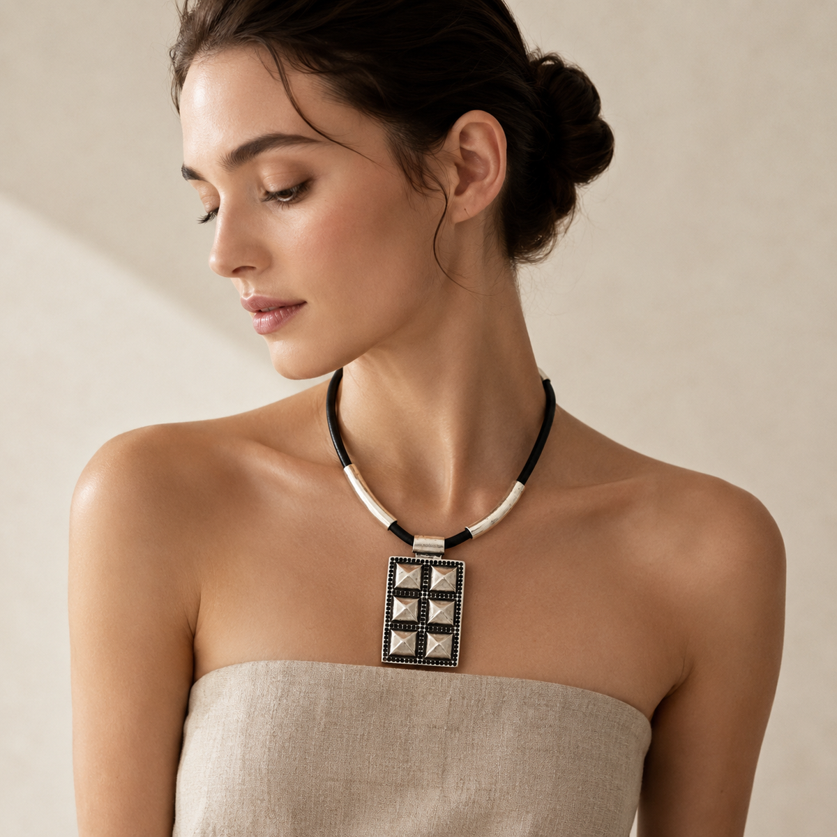 Black cord geometric pendant necklace with a modern rectangular pendant.