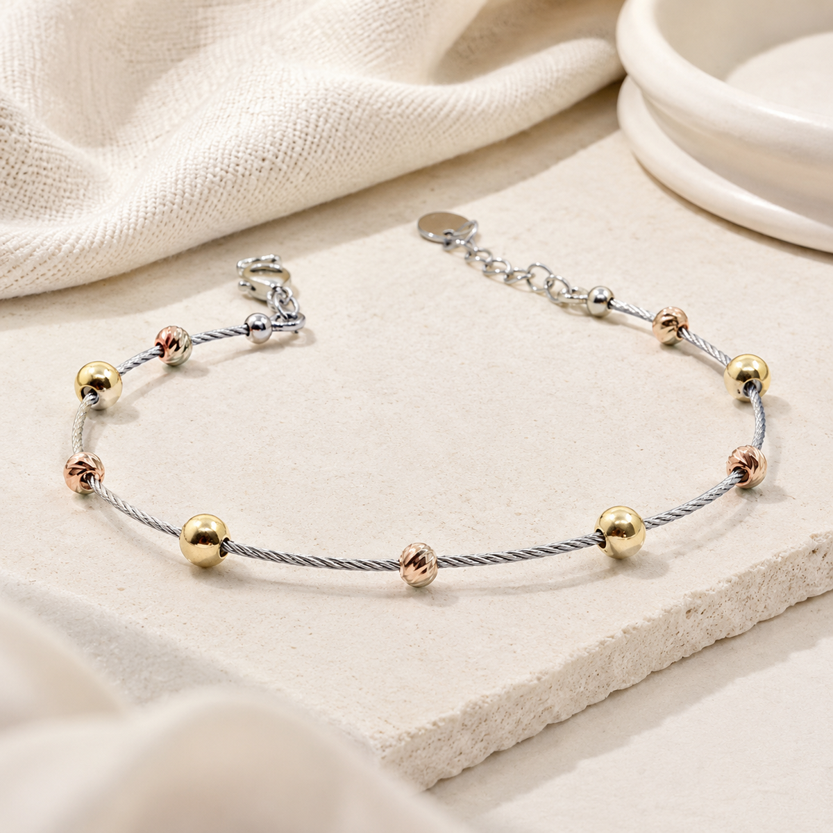 Angle view of the bracelet showing its slim chain and bead details.
