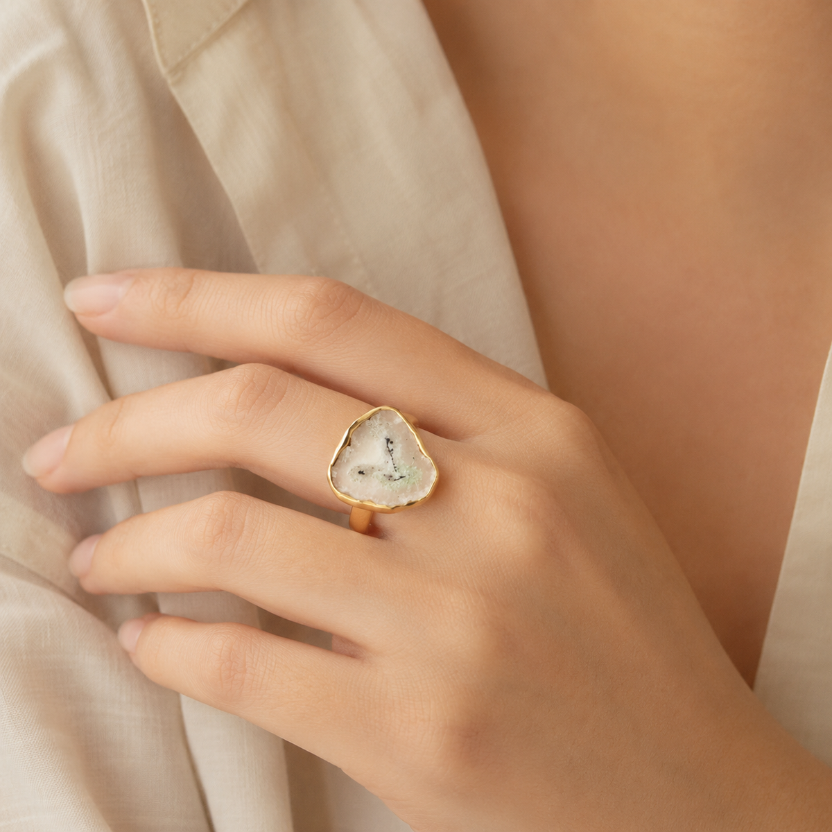 Solar quartz slice ring shown from the front with a gold-plated organic setting.