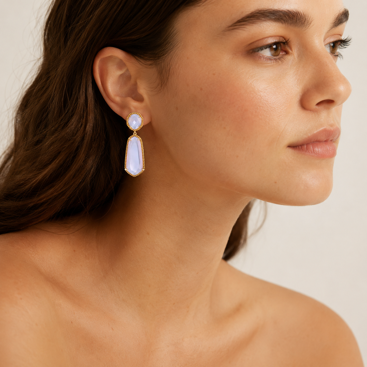 Lavender drop earrings with faceted stones and a gold-tone frame.
