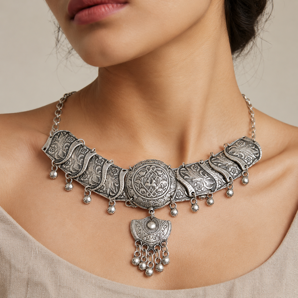 Silver-tone filigree choker necklace shown from above on a white background.