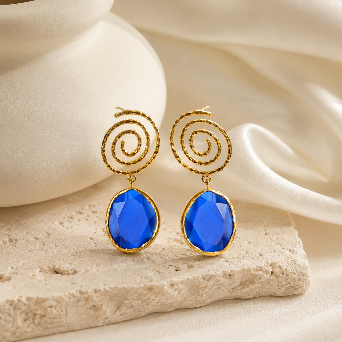 Gold-tone drop earrings with a deep navy blue accent.