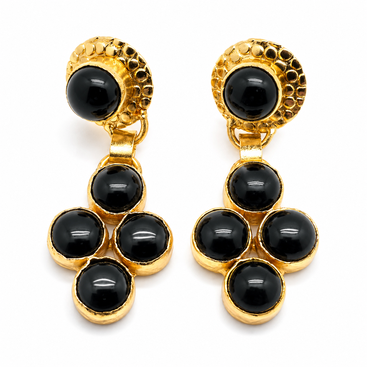 Gold-plated dangle earrings with glossy black onyx stones in a sculptural drop design.