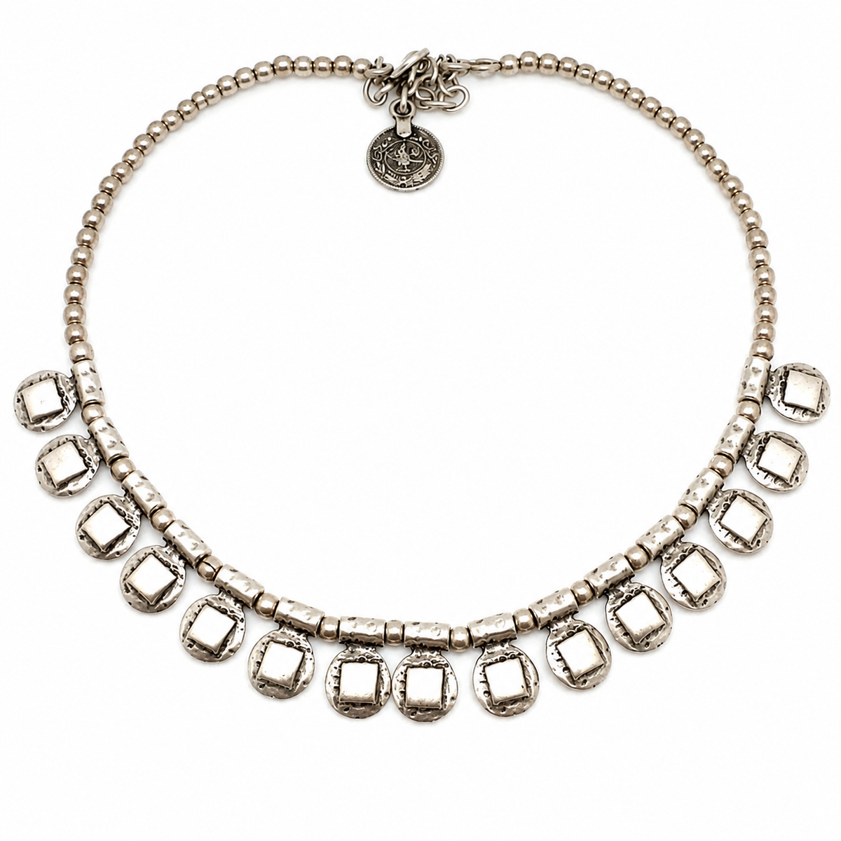 Silver-tone beaded necklace with square drop accents and a textured finish.