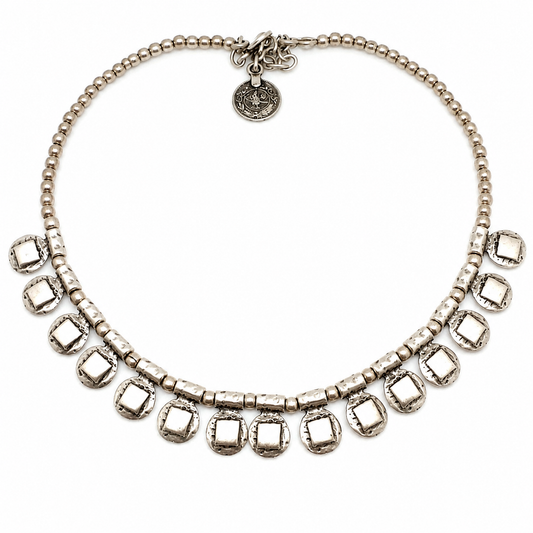 Silver-tone beaded necklace with square drop accents and a textured finish.