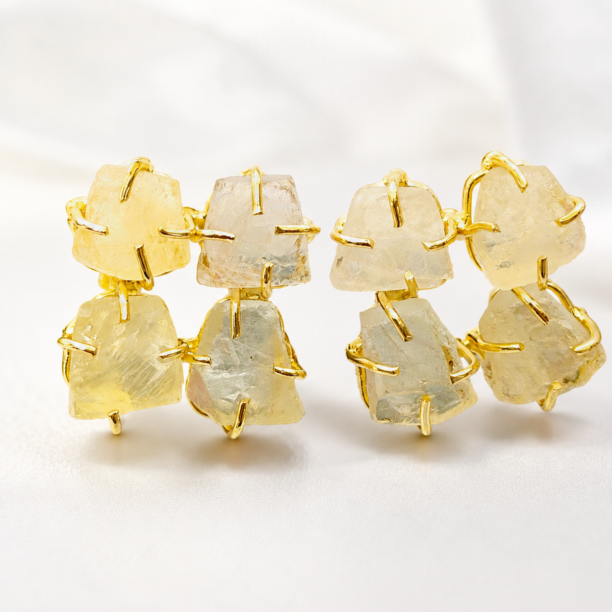 Close view of rough citrine stones set in gold plated metal.