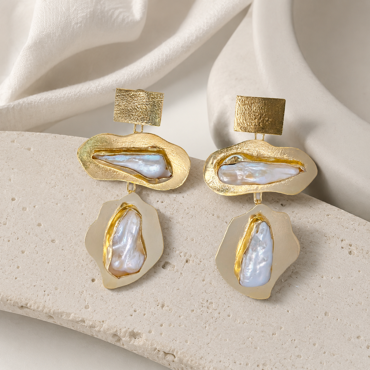 Gold-plated baroque pearl earrings with an organic sculptural silhouette.
