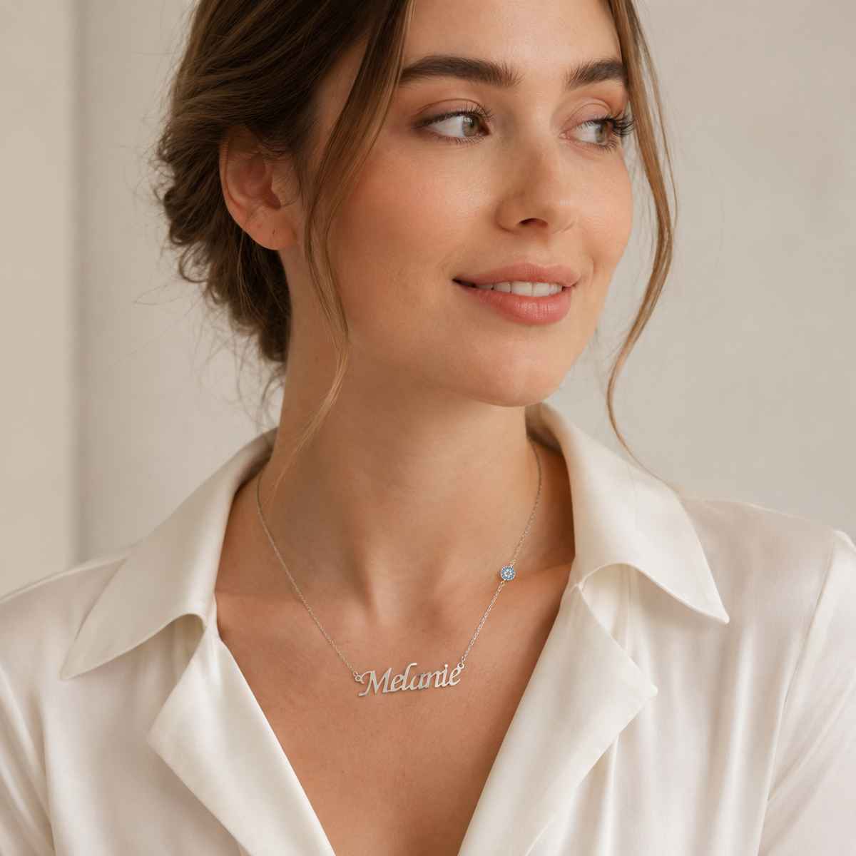Personalized engraved name necklace with a delicate chain and script pendant.