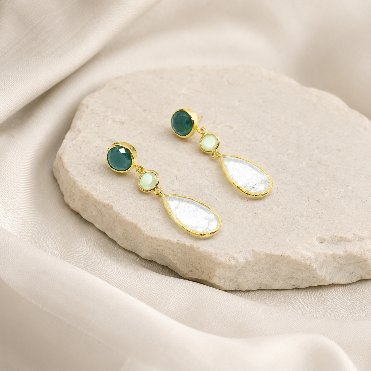 Gold-plated drop earrings with a multi-stone design on a white background.