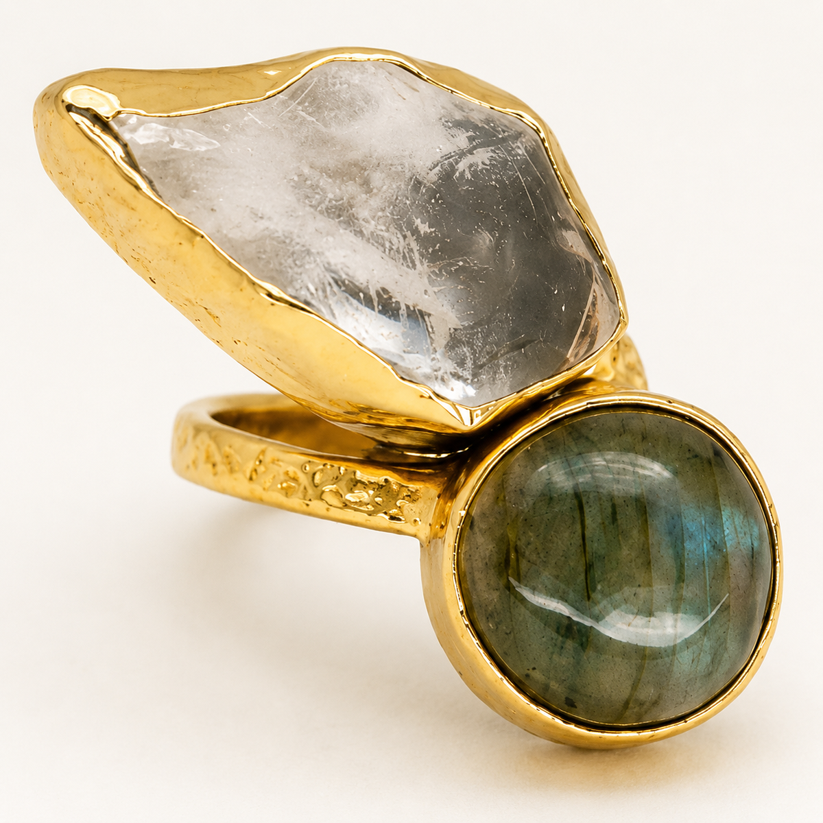 Close-up of a two-stone gold-plated ring with clear quartz and labradorite.