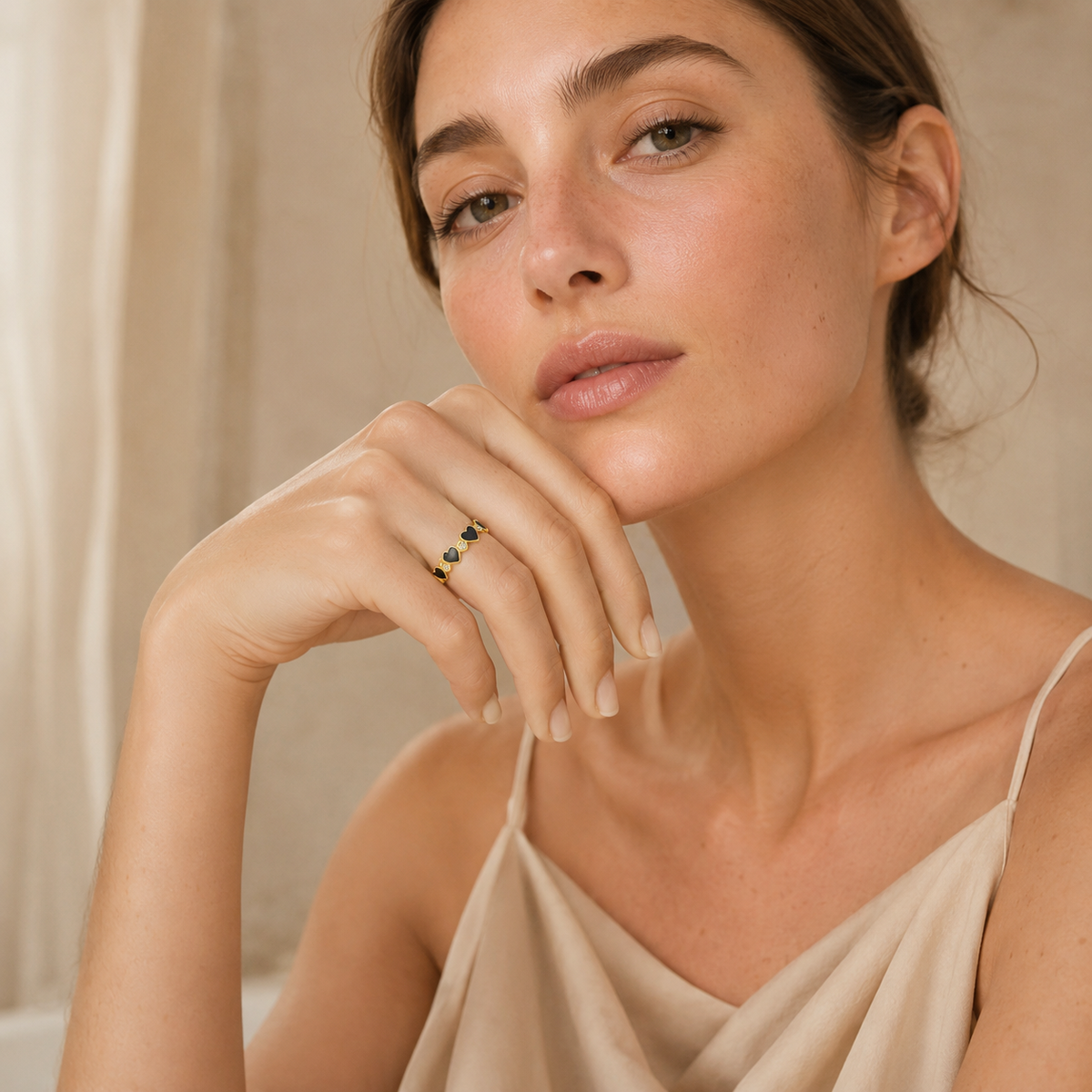 Black heart ring with clear CZ details and a polished gold-tone finish.