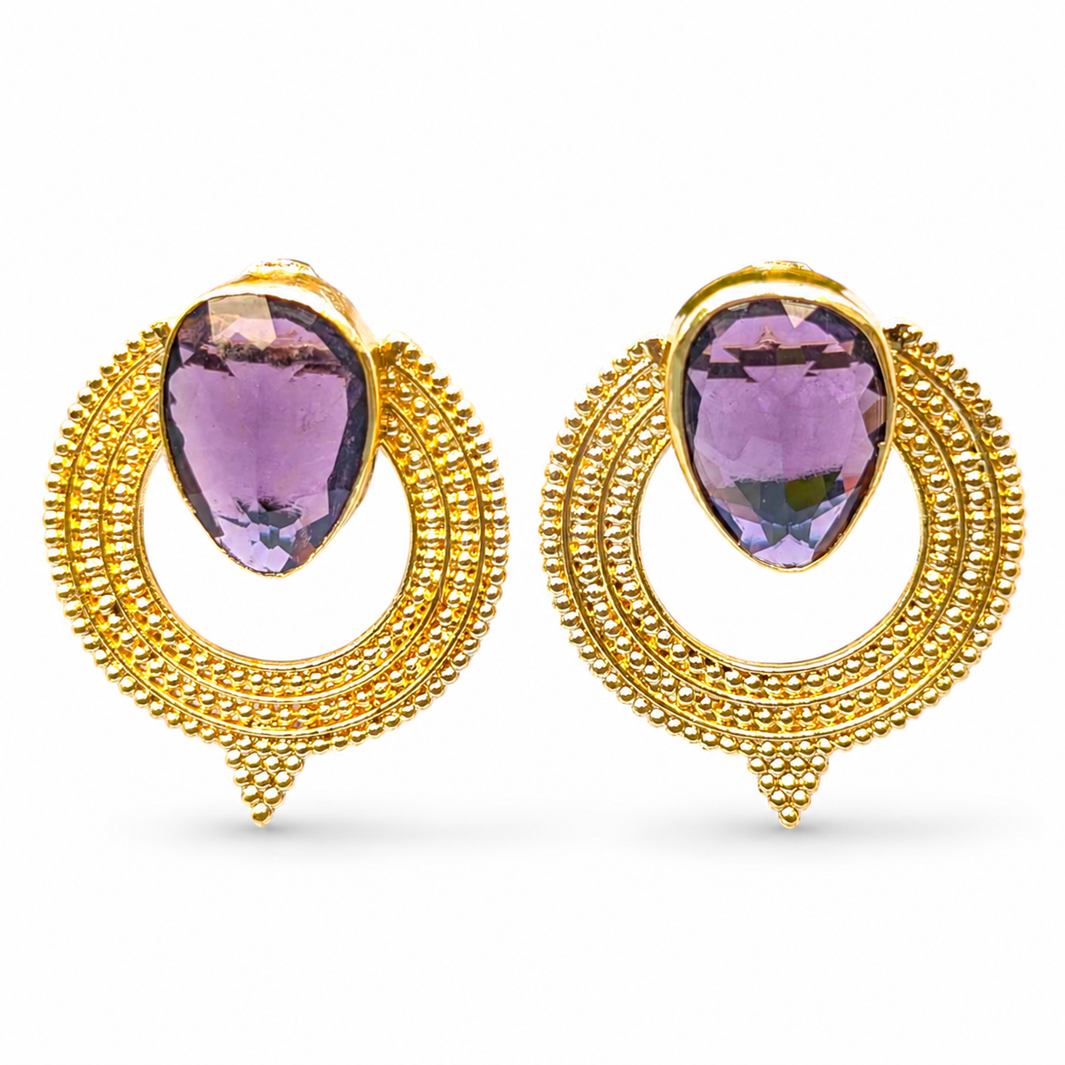 Pair of gold-plated earrings with purple CZ stones and a circular textured design.