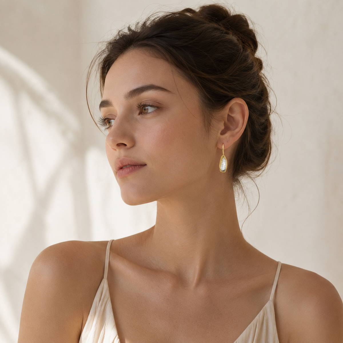 Gold-plated hook earrings with clear quartz drops.
