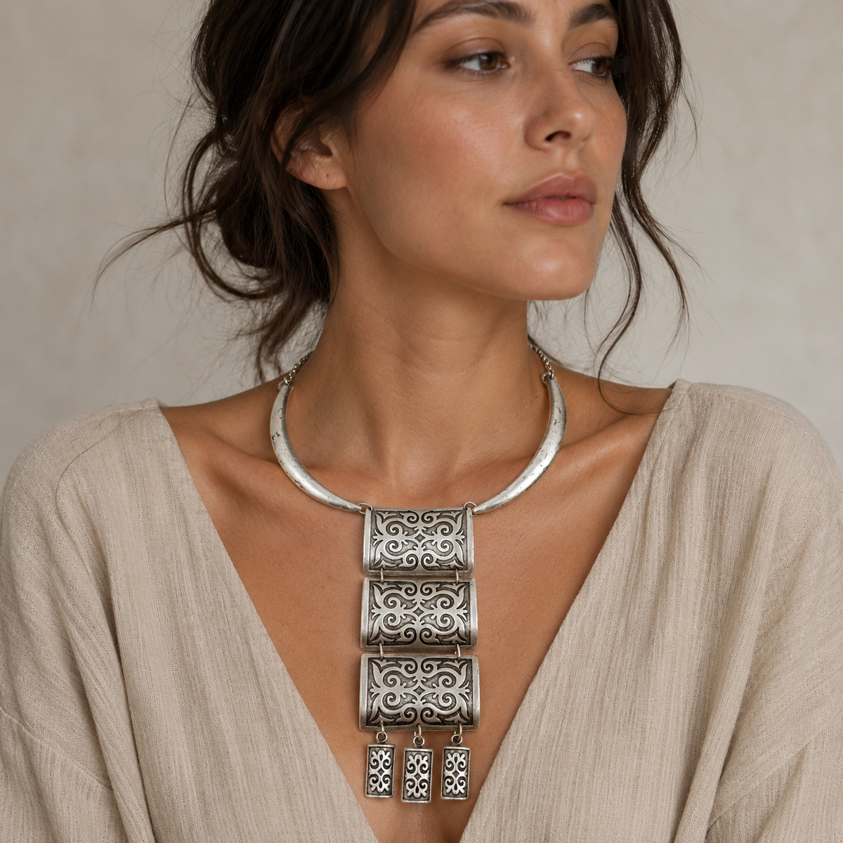 Silver-tone necklace with decorative panel pendant and fringe drops.