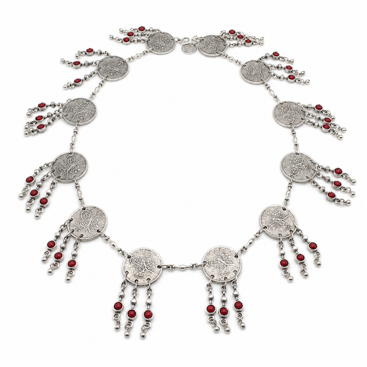 Silver-tone necklace with coin discs and red bead fringe arranged in a circular shape.