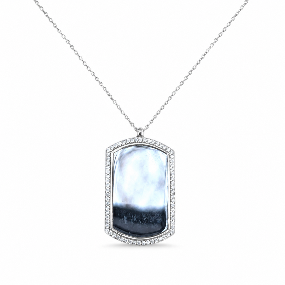 Dog tag necklace with a reflective center stone and CZ border on a slim silver-tone chain.