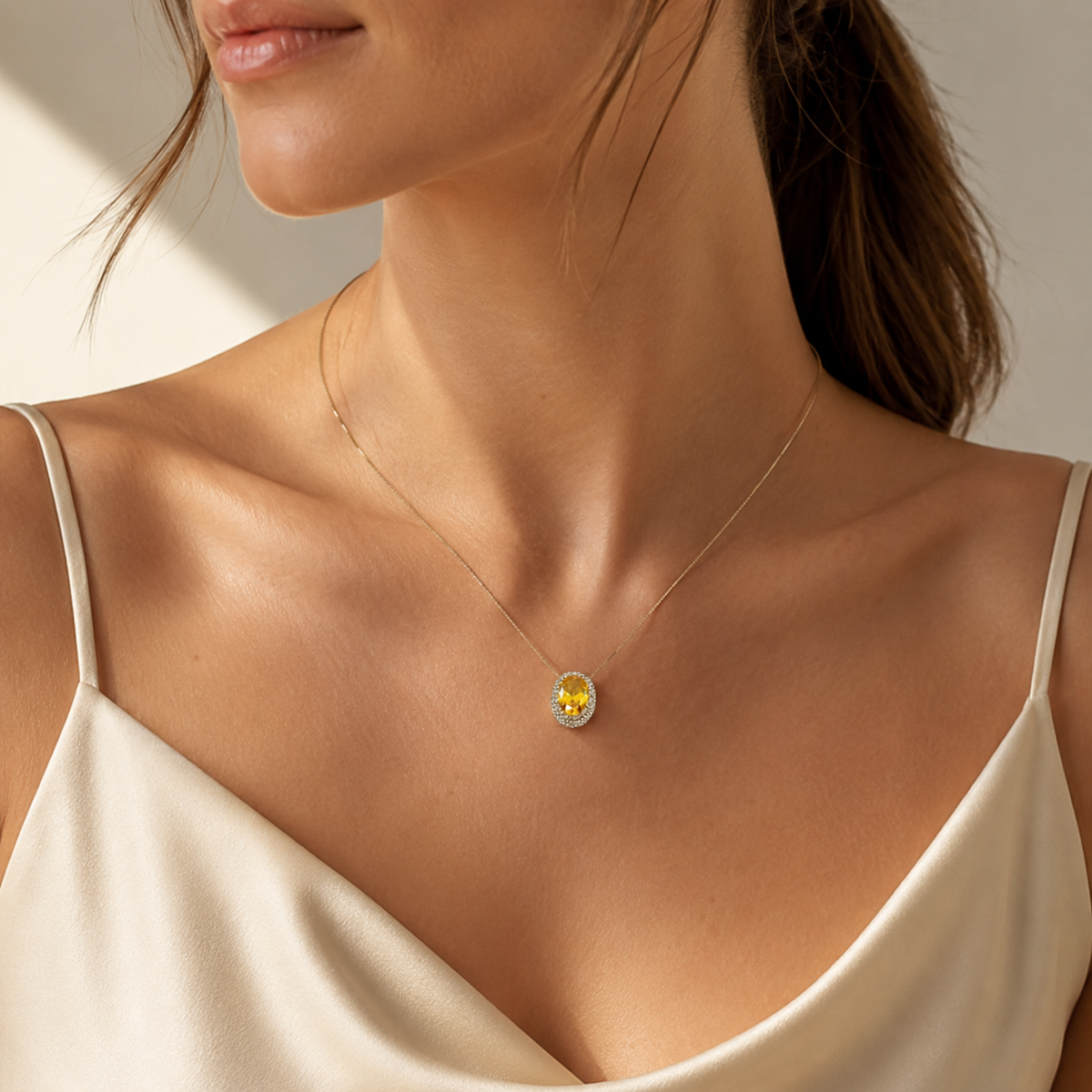 Gold-tone necklace with a bright oval citrine pendant.