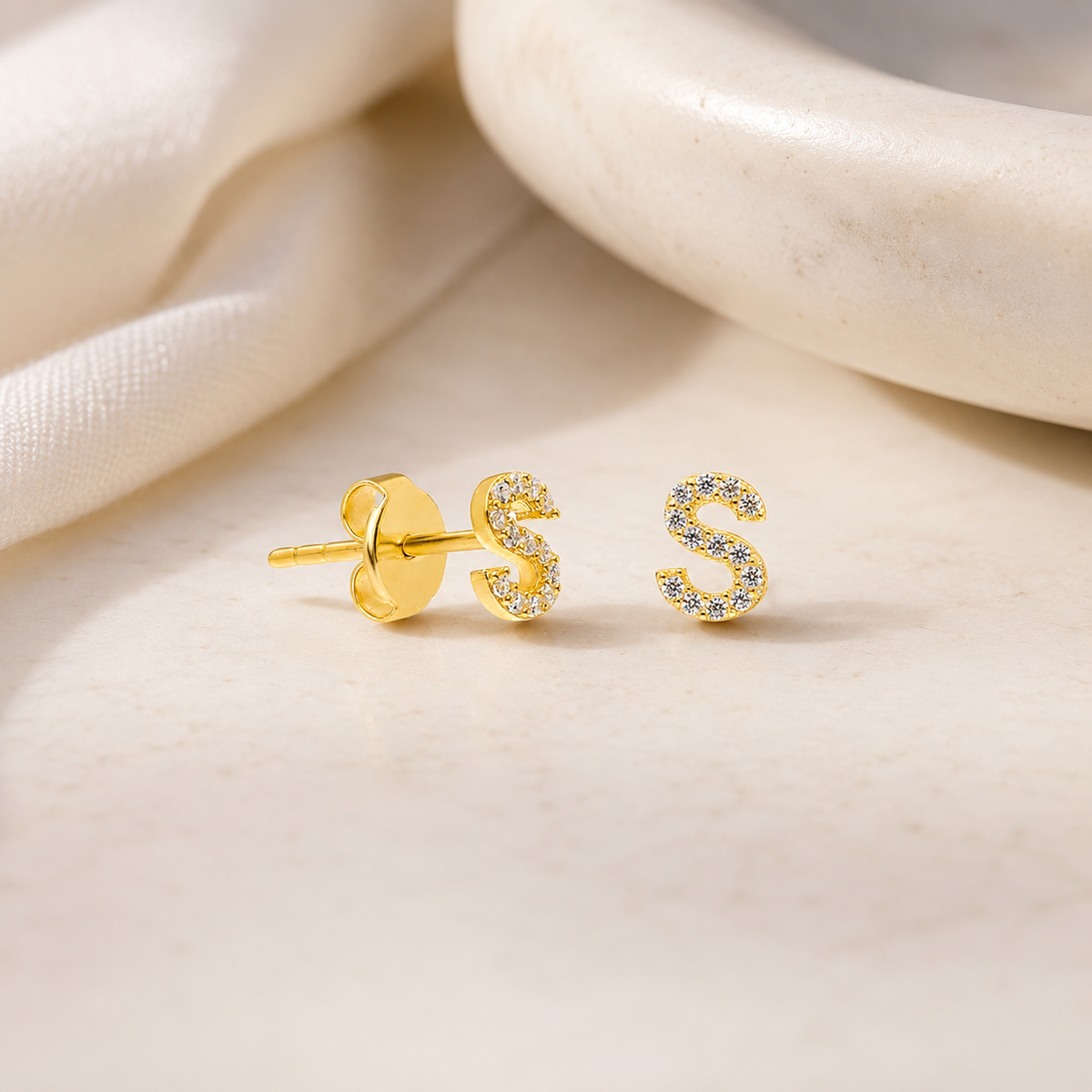 Gold-tone initial stud earring with a sparkling CZ outline.
