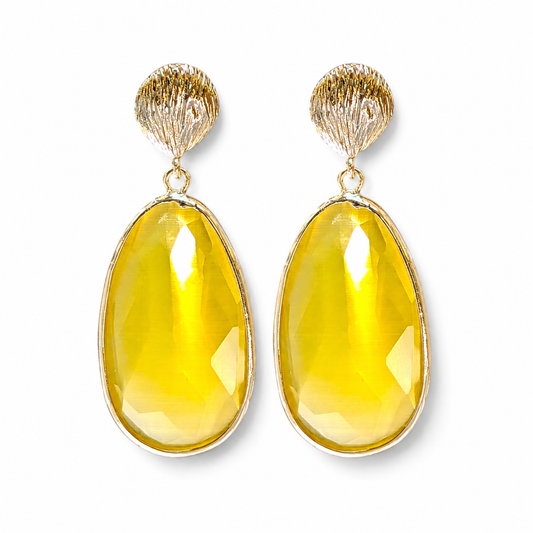 Pair of gold-tone statement drop earrings with textured shell tops and faceted yellow cat eye drops.