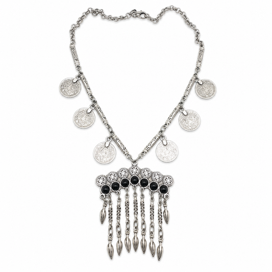 Silver-tone bib necklace with coin charms, black stone accents, and a fringe pendant design.