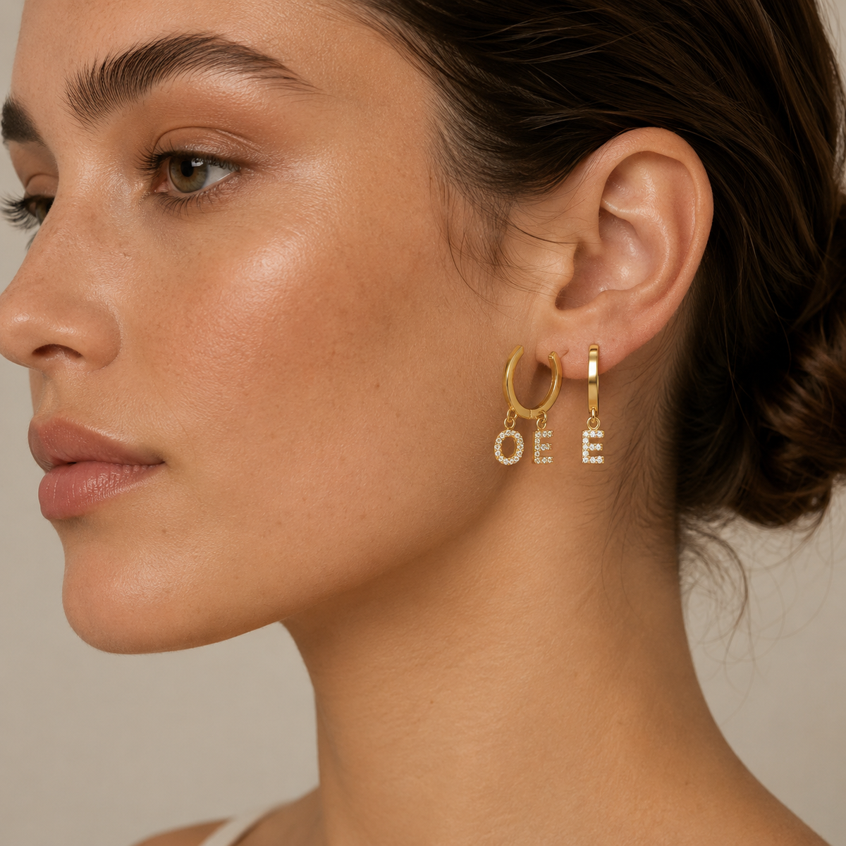 Gold-tone personalized hoop earrings with sparkling initial charms.