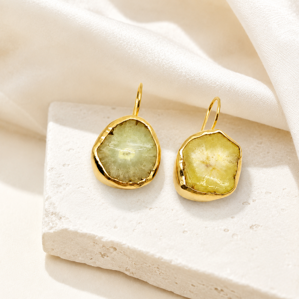 Gold-plated raw garnet hoop earrings with an organic, polished silhouette.