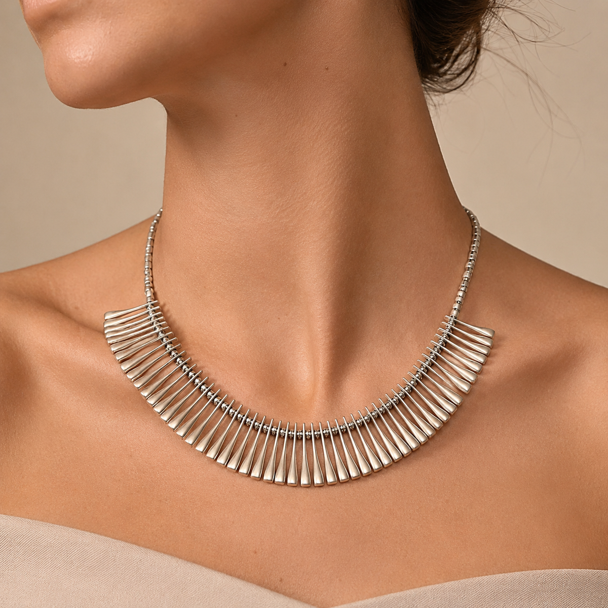 Silver-tone ribbed fan collar necklace shown on a white background.